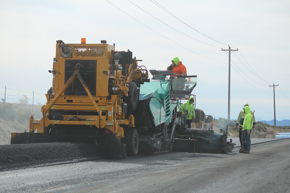 Crews repave Silica Road west of Quincy in April. Widening and repaving has contributed to better traffic flow at the Gorge Amphitheater, county officials said.