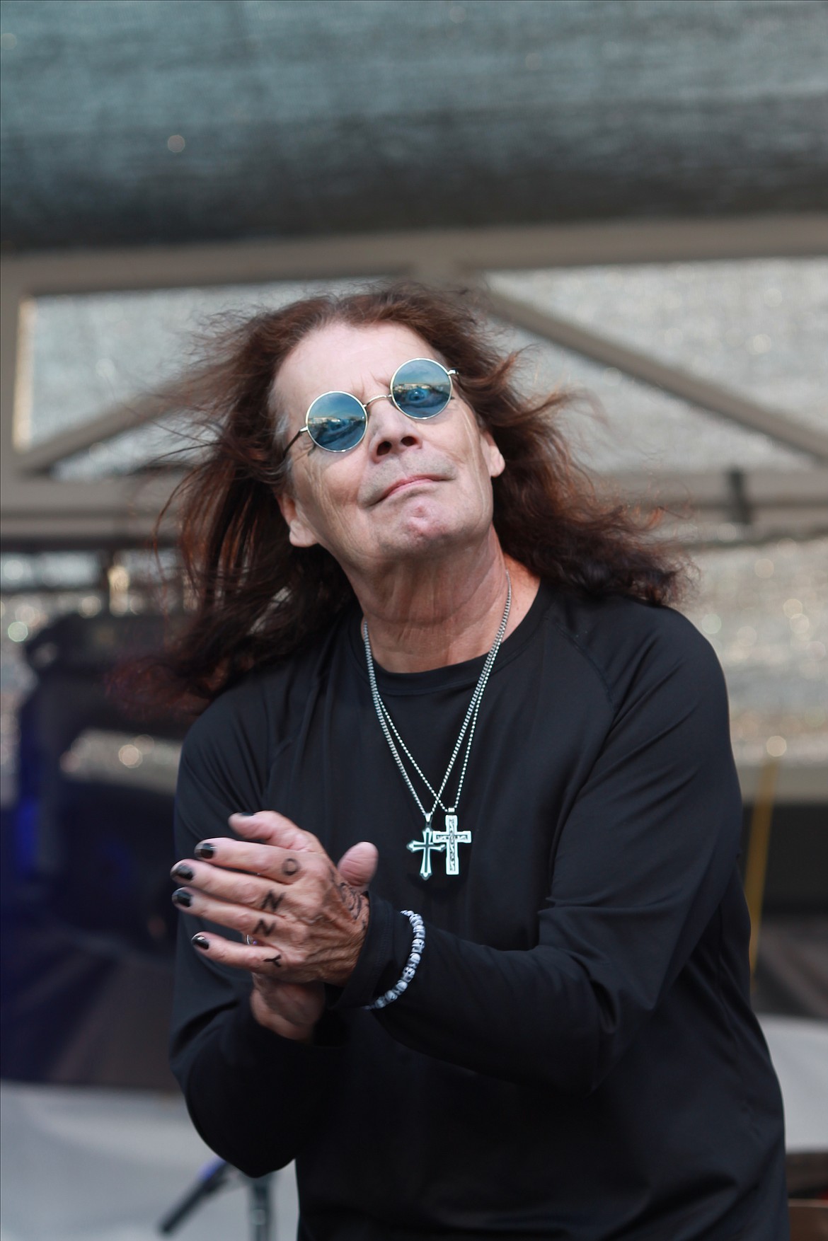 Vinny Cormier, lead singer of Crazy Train, an Ozzy Osbourne tribute band, claps to the beat during the Grant County Fair on Wednesday. Cormier has been a touring musician since 1977.