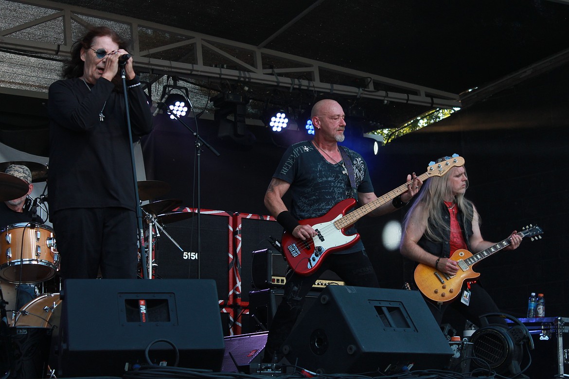 Vinny Cormier, left, Mikey Knowles, middle, and Dylan Cormier, right, perform on the – stage at the Grant County Fair on Wednesday. The three are part of a tribute band honoring Ozzy Osbourne.