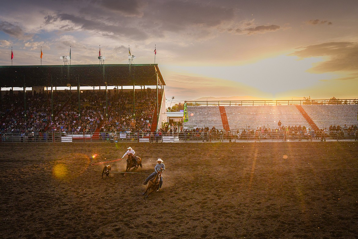 Alonzo Skunkcap, of Browning, and Nolan Conway, of Cut Bank, rope their steer during team roping as the sun shines through a light rain during the PRCA Rodeo at the Northwest Montana Fair & Rodeo on Thursday, Aug. 15. (Casey Kreider/Daily Inter Lake)