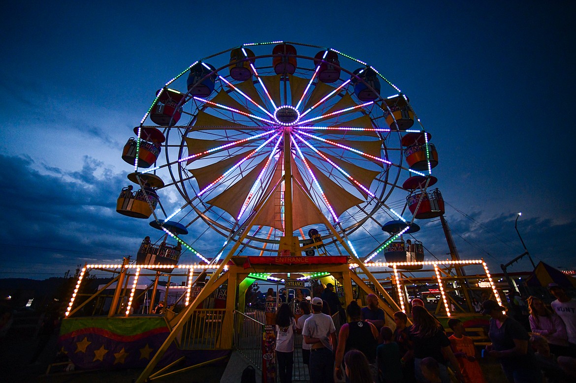 The ferris wheel lights up the sky at dusk at the Northwest Montana Fair & Rodeo on Thursday, Aug. 15. (Casey Kreider/Daily Inter Lake)