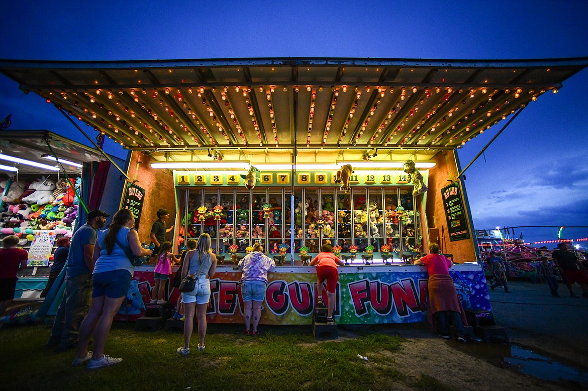 Attendees play Water Gun Fun! at the carnival at the Northwest Montana Fair & Rodeo on Thursday, Aug. 15. (Casey Kreider/Daily Inter Lake)