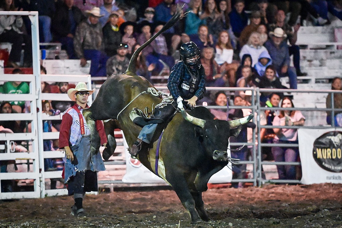 Octavius Christianson, from Columbia Falls, competes in bull riding at the PRCA Rodeo during the Northwest Montana Fair & Rodeo on Friday, Aug. 16. (Casey Kreider/Daily Inter Lake)