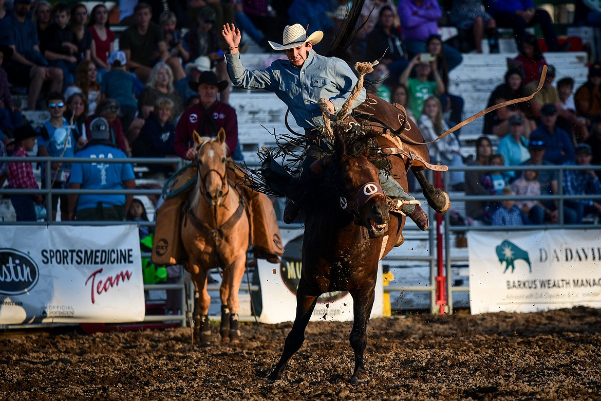 Bo Vocu, from Ashland, rides R Watsons The Duke during saddle bronc riding at the PRCA Rodeo during the Northwest Montana Fair & Rodeo on Friday, Aug. 16. (Casey Kreider/Daily Inter Lake)