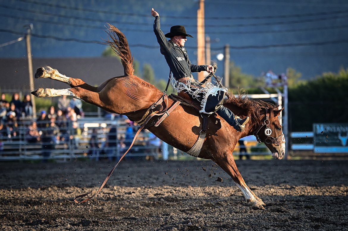 A horse and rider compete in saddle bronc riding at the PRCA Rodeo during the Northwest Montana Fair & Rodeo on Friday, Aug. 16. (Casey Kreider/Daily Inter Lake)