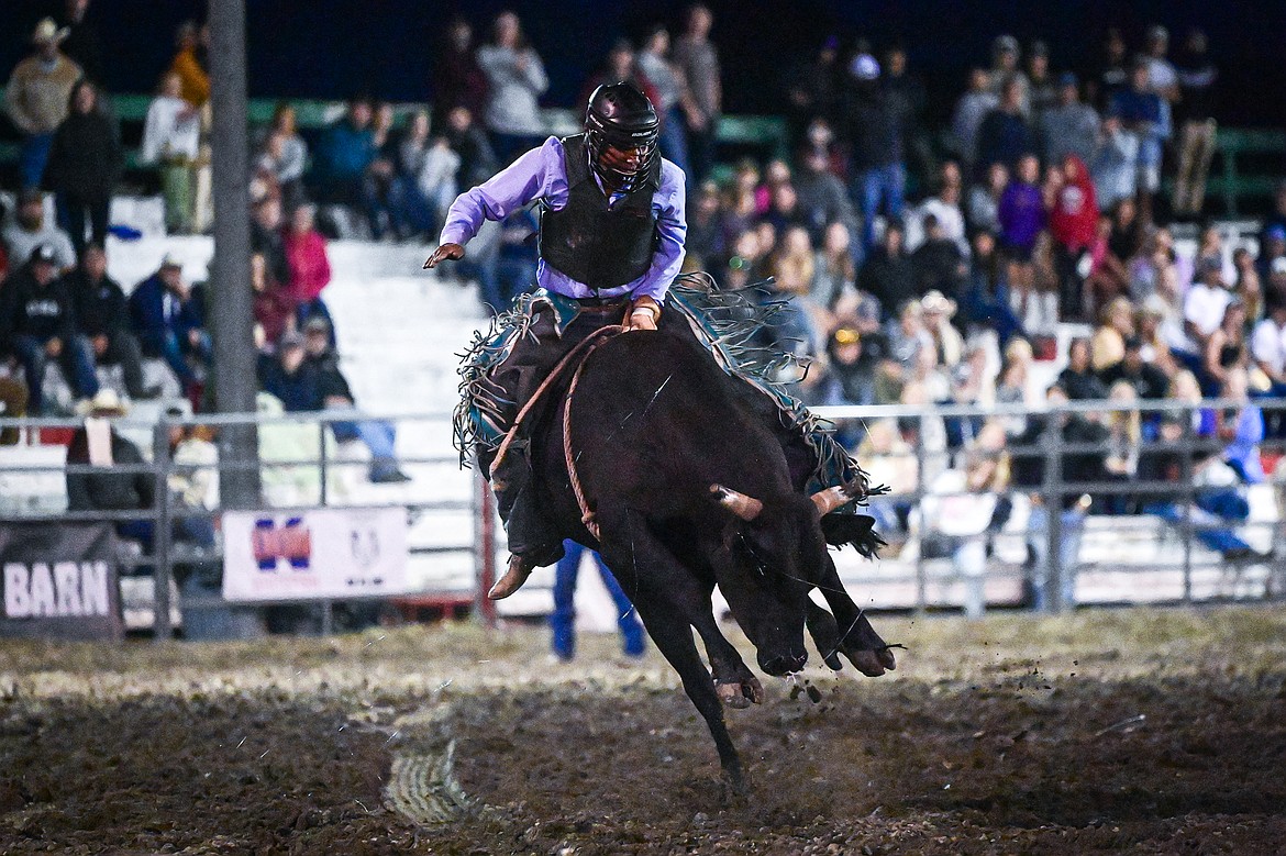 Travis Loring, from Browning, competes in bull riding at the PRCA Rodeo during the Northwest Montana Fair & Rodeo on Friday, Aug. 16. (Casey Kreider/Daily Inter Lake)