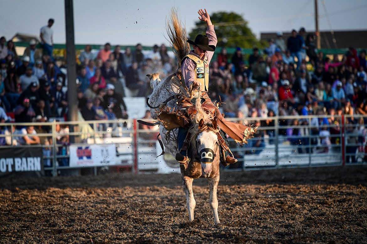 Kyle William Wanchuk rides Tupelo during saddle bronc riding at the PRCA Rodeo during the Northwest Montana Fair & Rodeo on Friday, Aug. 16. (Casey Kreider/Daily Inter Lake)