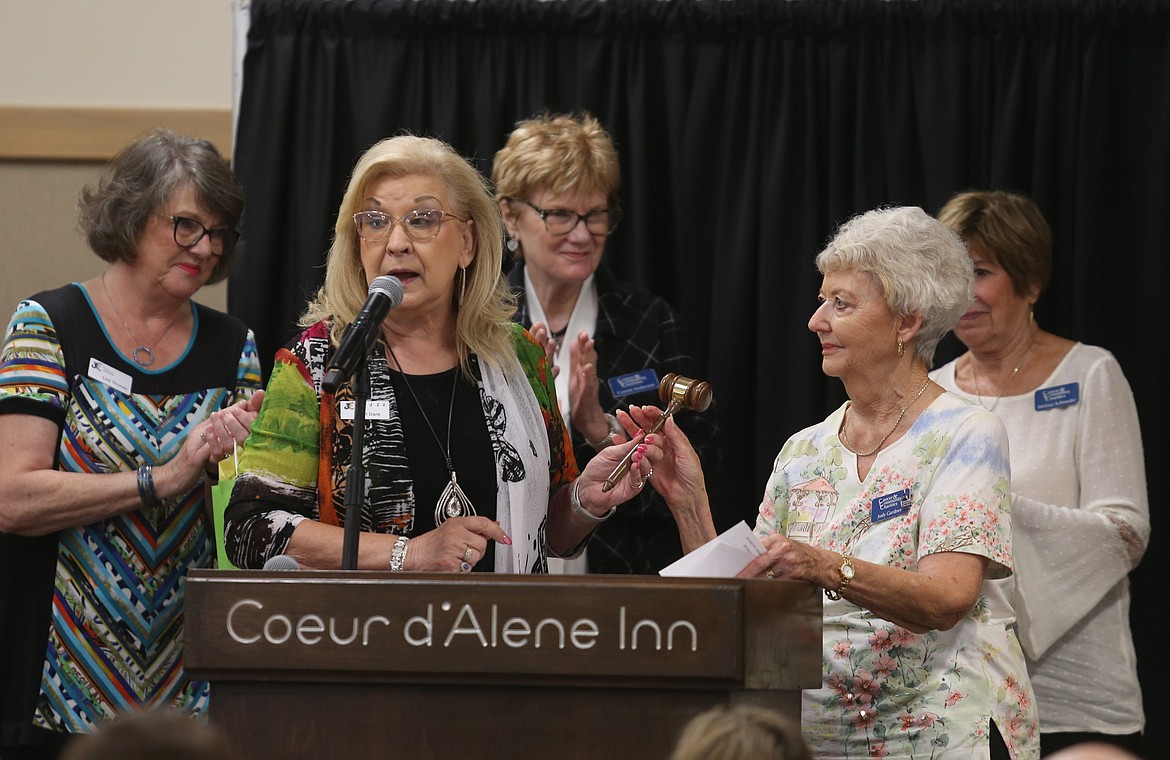 Outgoing President Ann Dare, front left, hands the gavel to incoming President Judy Gardner during the 3Cs' 2024 officer installation ceremony, Appreciation Lunch and grant funds distribution Friday at the Best Western Plus Coeur d'Alene Inn.