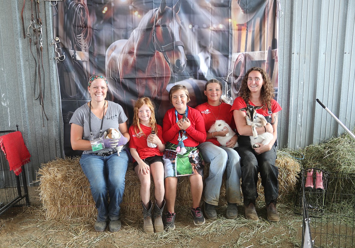 Kari Gruner, LInnea York, Sage Piatt, Abigail Belgarde, and Makayla Gruner pose Friday with a few of the critters available to meet at Kari's Kritterz Petting Zoo, one of the events being held at the Bonner County Fair.