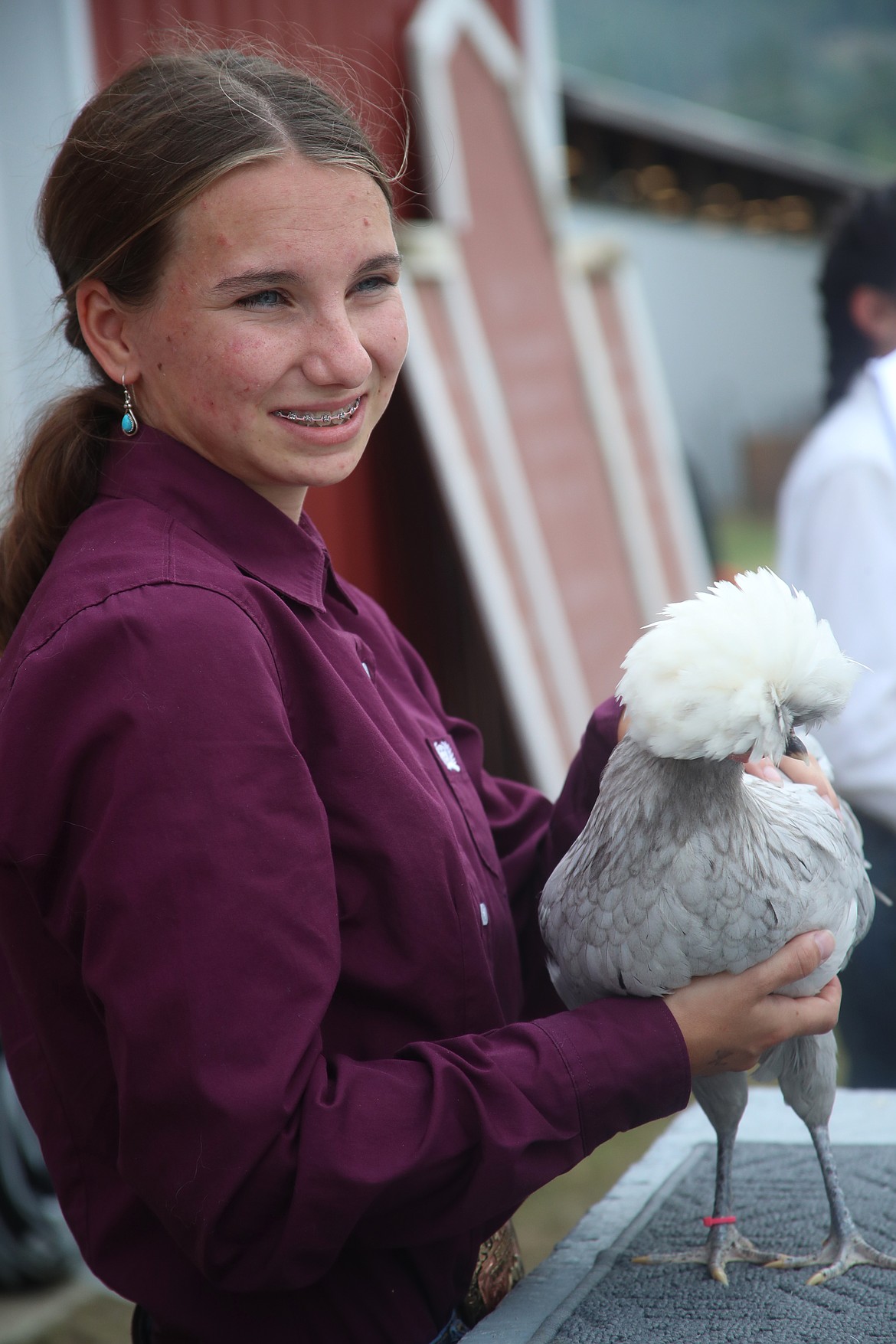 Karli Lippert shows her white-crested Blue Polish Chicken at the Bonner County Fair on Friday.