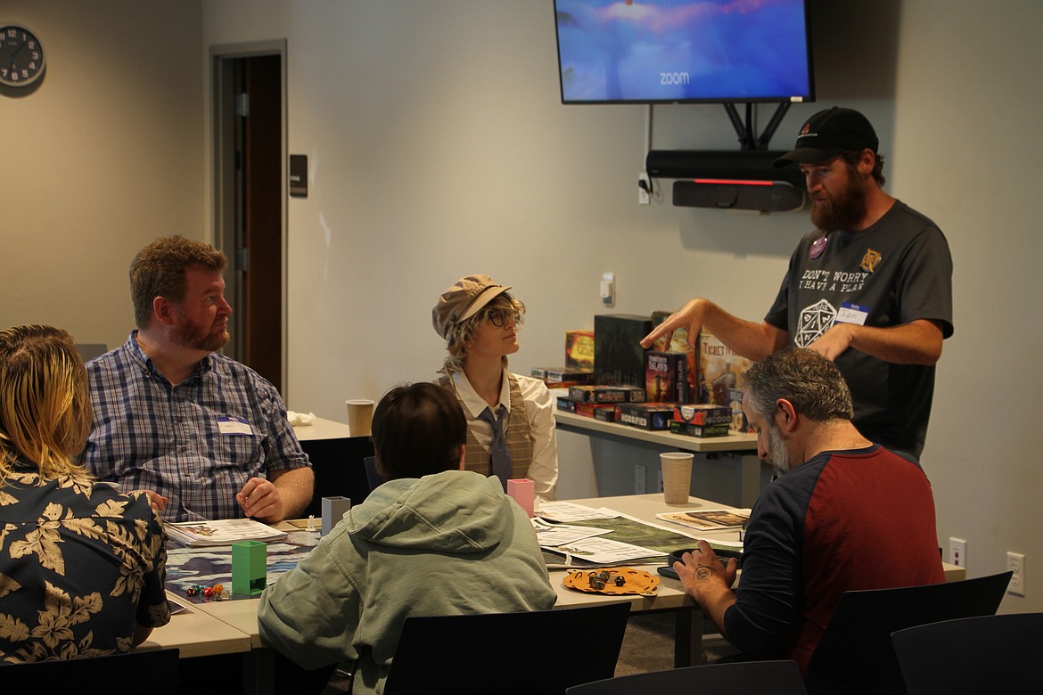 Attendees prepare to play Pathfinder, a tabletop fantasy role-playing game, in a common room at the library.