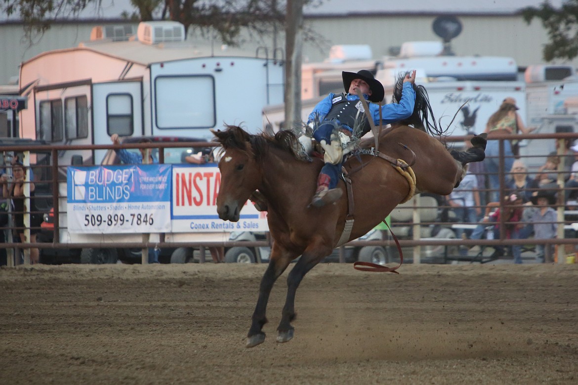 Bareback rider Jacek Frost, of Browns Valley, Calif. maintains his balance on top of his horse at the Moses Lake Roundup on Thursday.