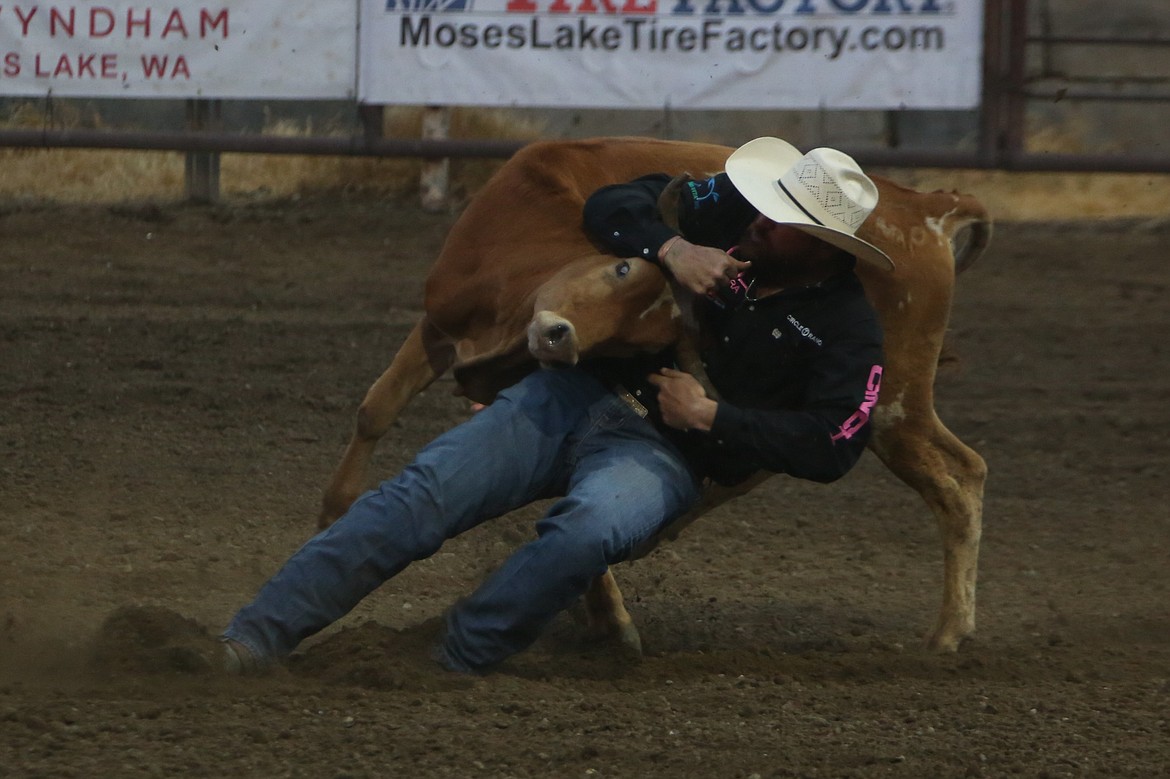 Steer wrestler Jason Thomas, hailing from Benton, Ark., takes down a steer at Thursday’s edition of the Moses Lake Roundup.