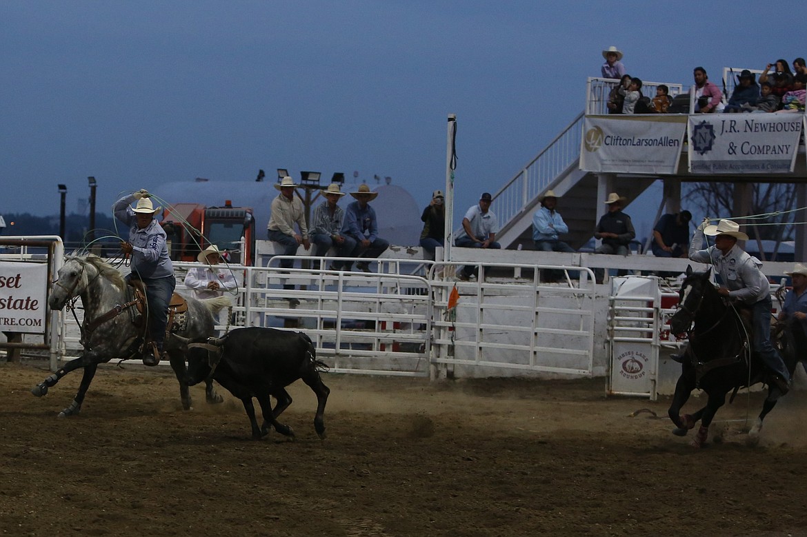 The team roping duo of Clayton Hansen and Chase Hansen work to rope a steer on Thursday.