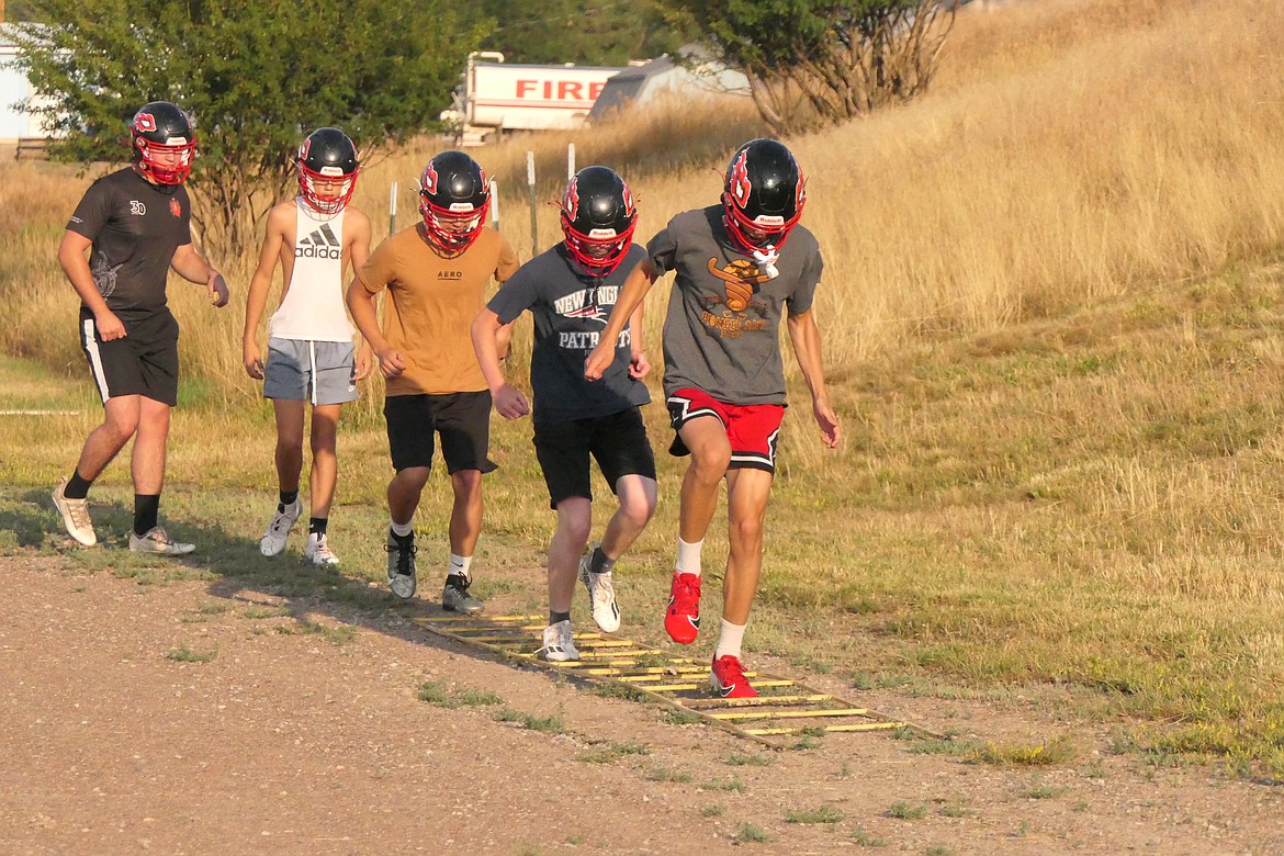 Savage Heat football players step through and agility drill then run up the hill during their first practice of the 2024 season last Friday in Hot Springs. (Chuck Bandel/VP-MI)