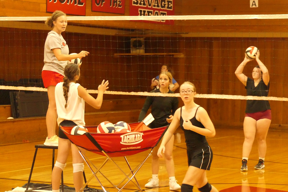 Hot Springs volleyball coach Maria Begger works with her team during a recent practice at the old gym in Hot Springs. (Chuck Bandel/VP-MI)