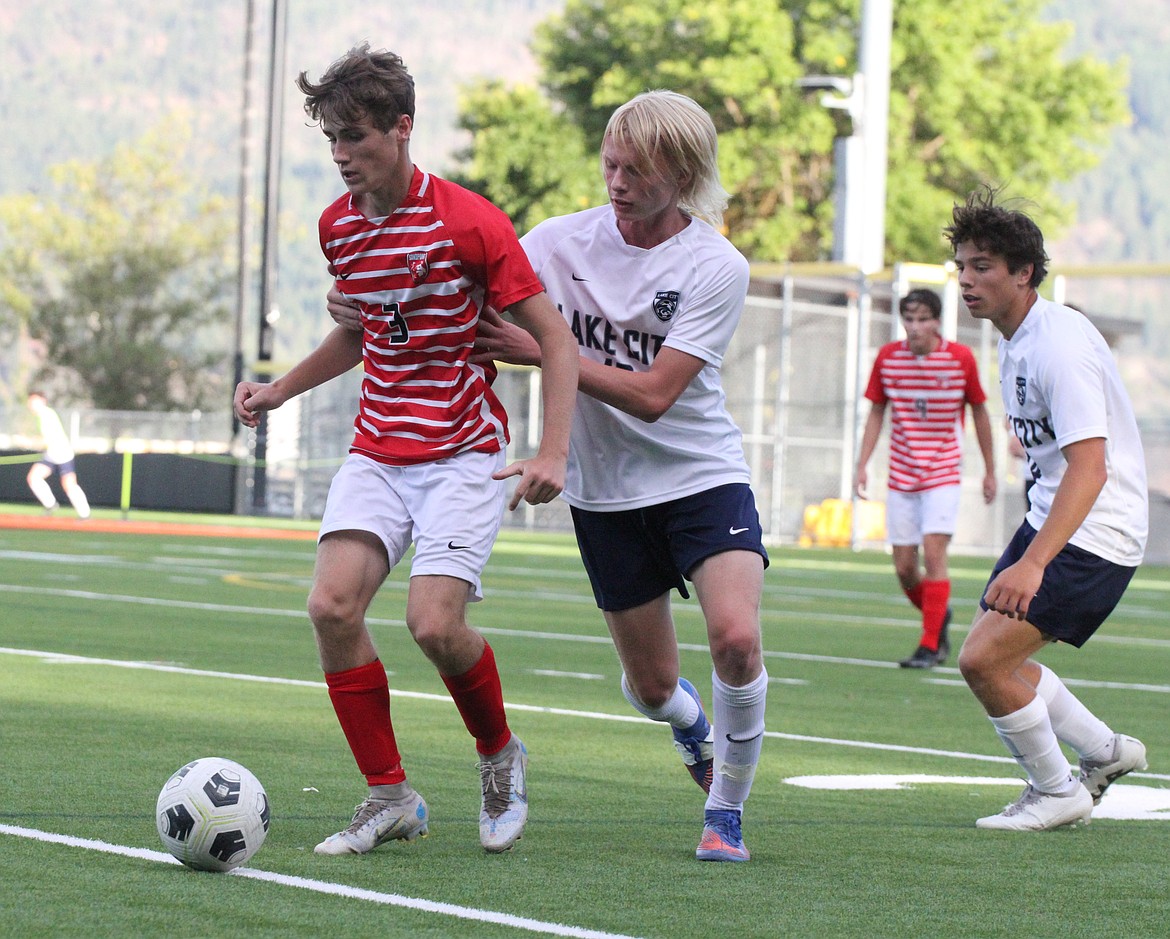 Sandpoint High senior Luke Leavitt fights off a Lake City defender during a Bulldogs home game last season.