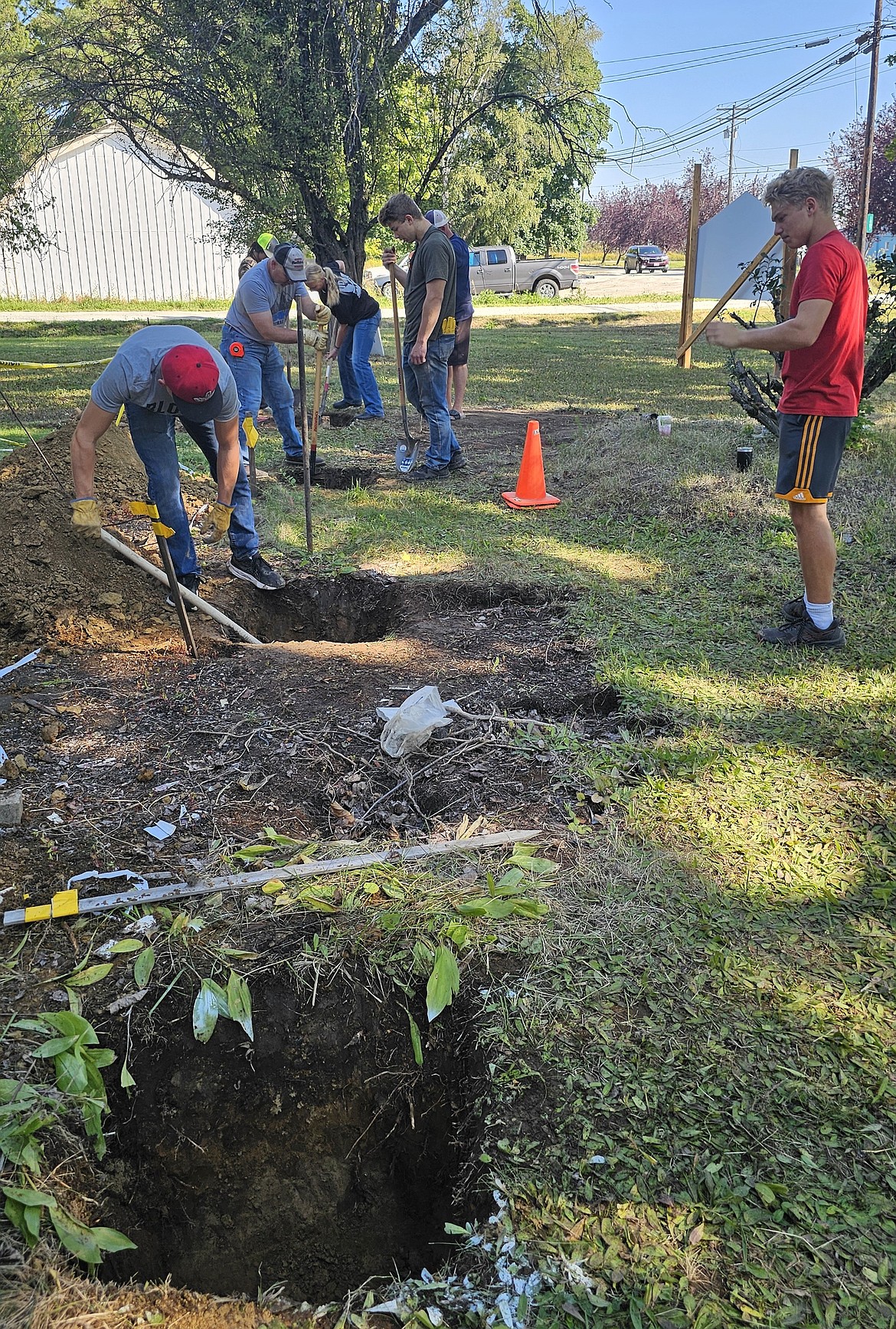 The Sandpoint High wrestling crew, along with some other volunteers, finish up work on Saturday. The four holes that were dug, as seen in this picture, will serve as the foundation for a new front porch. The work took about an hour, as the soil had lots of roots in it. John Elsa, a local for 46 years, and a PSNI volunteer for more than six years, originally asked the team if they had any athletes that were willing to lend a helping hand. He said the new front porch of The Cottage will have an overhang; the previous porch did not, and the piling up of snow ruined it. Elsa, an electrical contractor by trade for many years before his retirement, used to help PSNI out when they had electric problems. "Panhandle Special Needs is a great organization," Elsa said. "They help adults with disabilities and we are fortunate to have that here, because not all communities have access to something like this." If interested in PSNI's services, visit panhandlespecialneeds.org/contact, email info@panhandlespecialneeds.org, or call 208-263-7022.