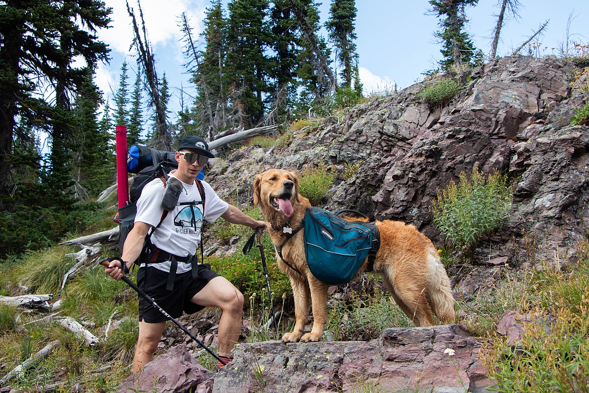 Brandon Phillips, owner of Glacier Hikes and Bikes, and his dog Juniper, on an overnight pack raft trip around Holland Lake. (Kate Heston/Daily Inter Lake)