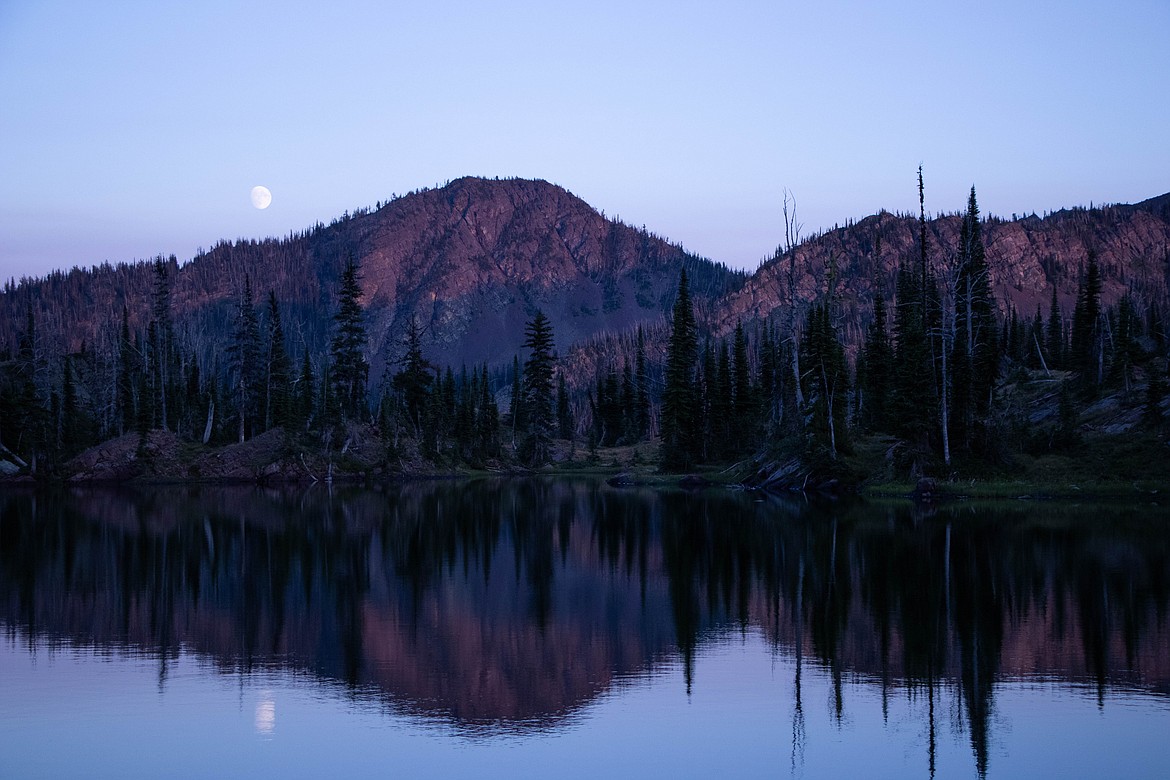 The moon rises as the sun sets over an alpine lake in the Swan Range. (Kate Heston/Daily Inter Lake)