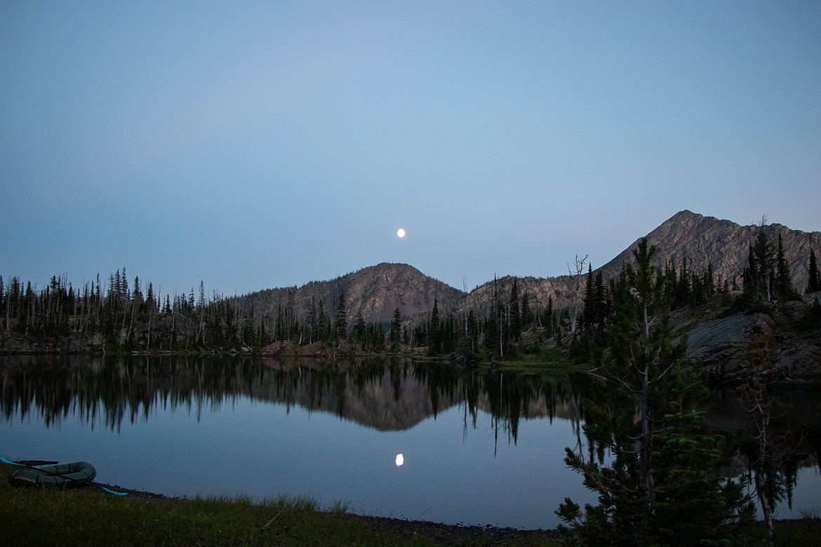 The moon rises as the sun sets over an alpine lake in the Swan Range. (Kate Heston/Daily Inter Lake)