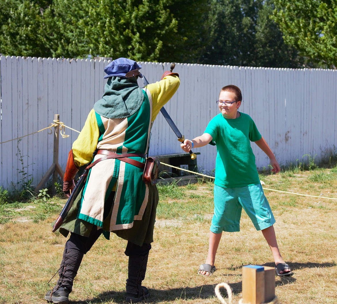 A young squire practices his swordsmanship.