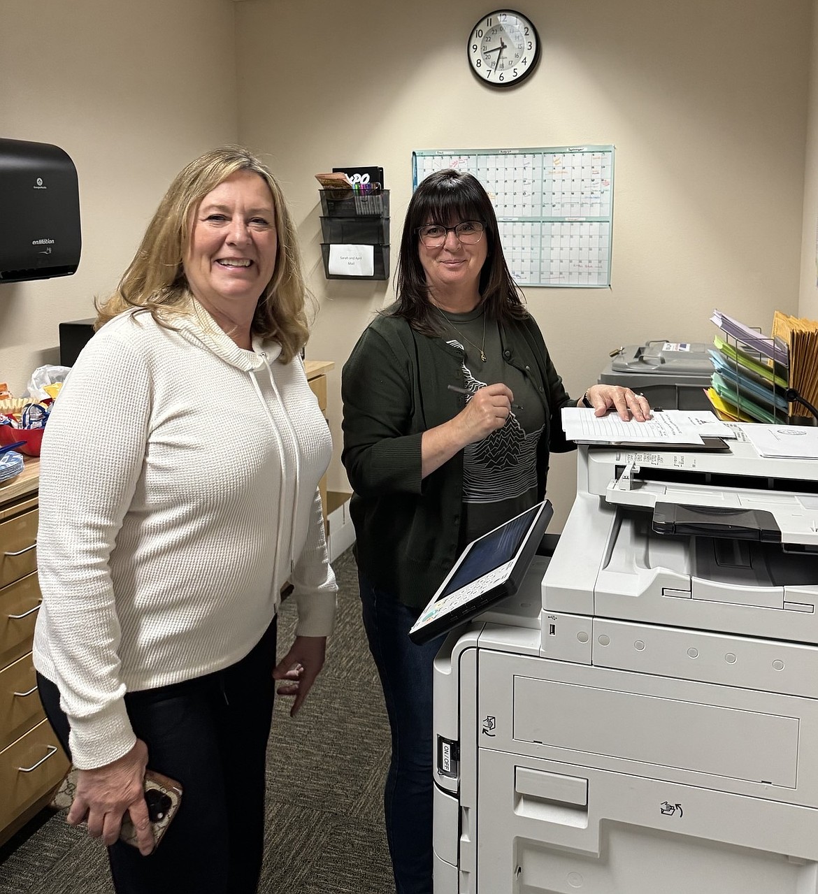 Knudtsen Automotive Group President Eve Knudtsen, left, and Patricia Phillips in the North Idaho College business office are seen on campus Wednesday as Knudtsen files official paperwork to run for a seat on the college's board of trustees.