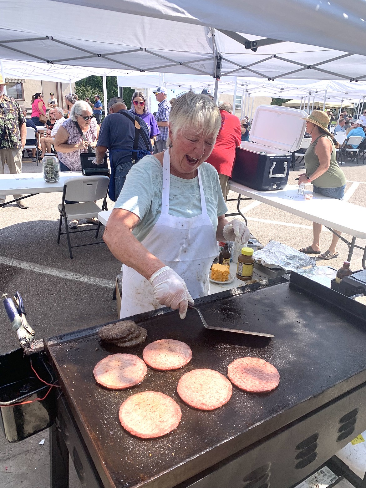 Jo Durand of the Polson Elks Club flipped burgers for the Rotary Brewfest, held Aug. 10 in Polson. (Polson Rotary photo)