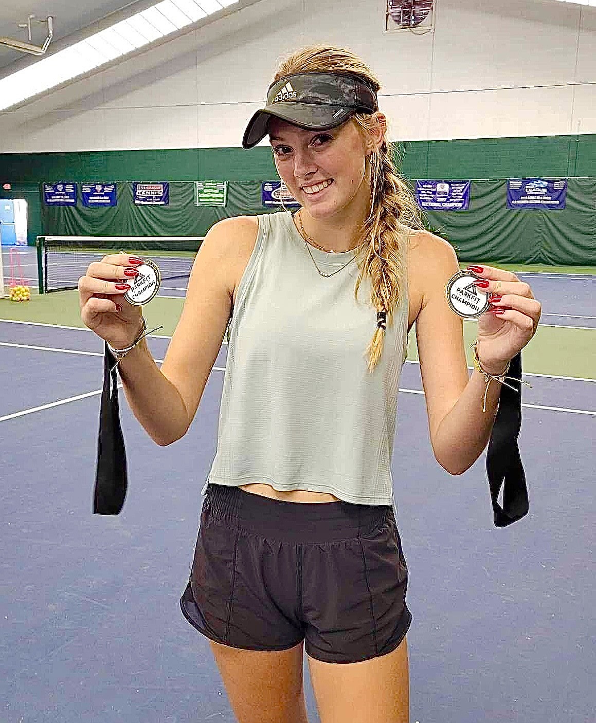 Sandpoint High rising sophomore Pepper Rickert shows off the gold medals she won in U16 singles and U18 doubles.