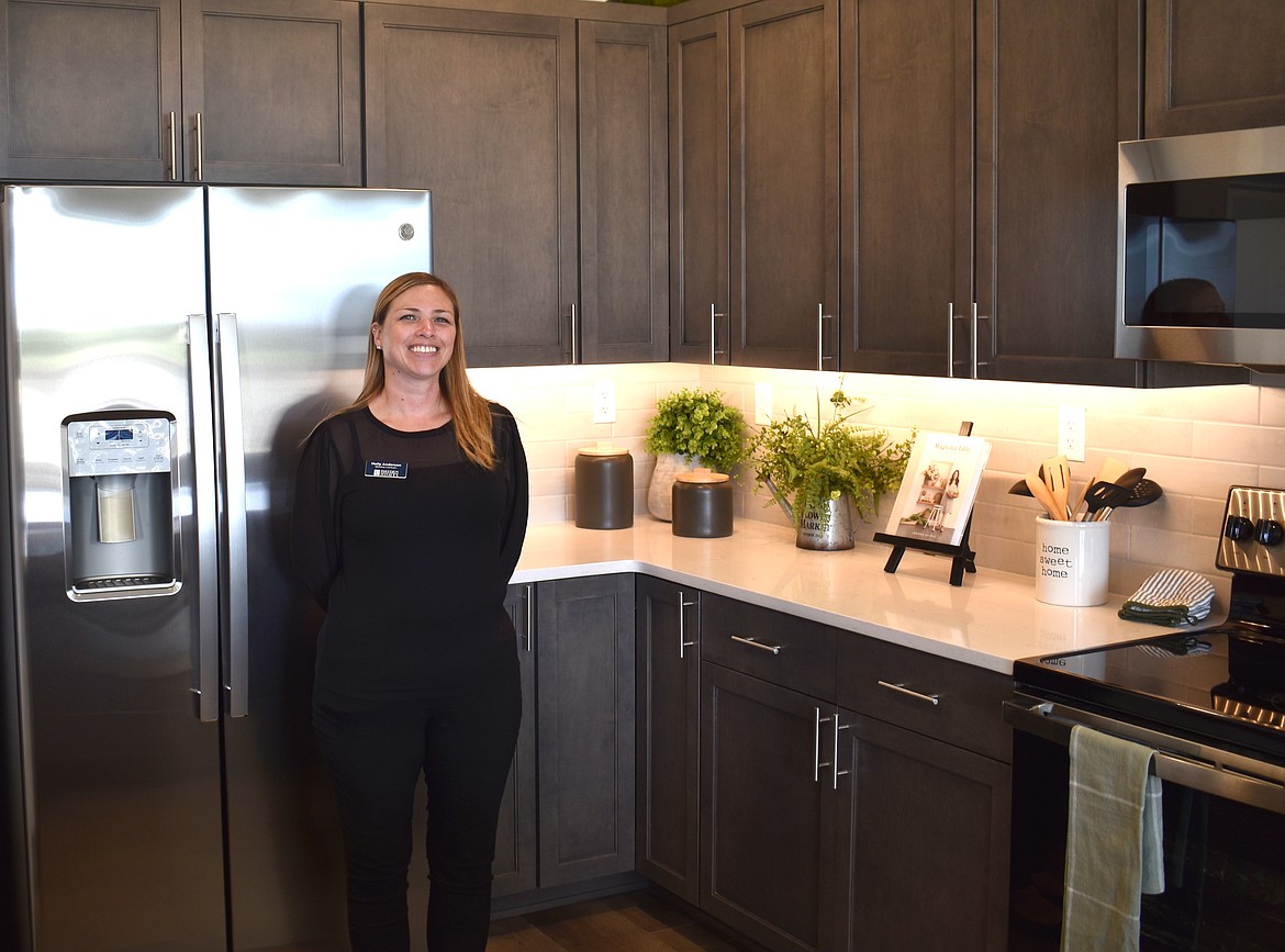 Hayden Homes Marketing Coordinator Holly Anderson stands in the kitchen of the model home at Polo Ridge, Hayden’s newest development in Moses Lake.