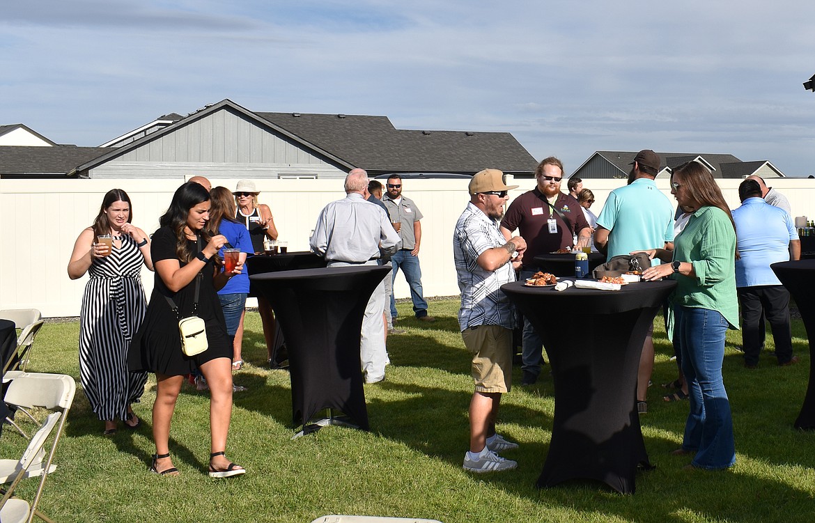 Members of the Moses Lake Chamber of Commerce mingle at a special Business After Hours event in the back yard of the model home at Polo Ridge.