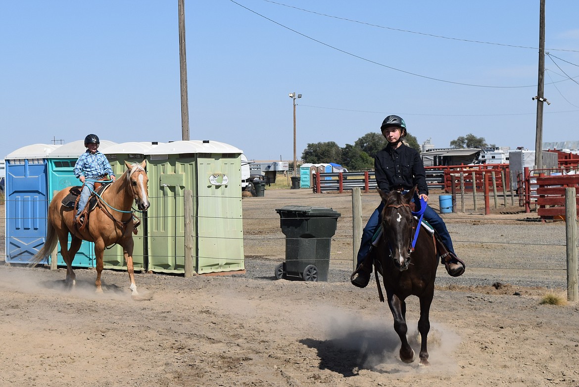 Two young Western-style competitors walk their horses around the ring at last year’s Wheat Land Communities’ Fair. This year’s fair begins Aug. 28.