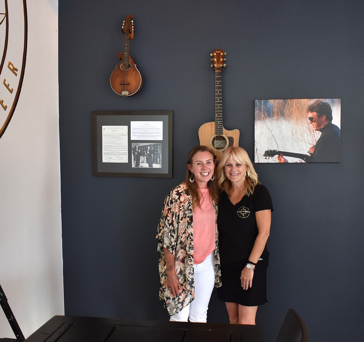 Nickey Groff, left, and Moore Brewing co-owner Lorie Moore stand in front of memorabilia from Groff’s grandfather Wayne Thomas and Moore’s father, who was also an avid musician.