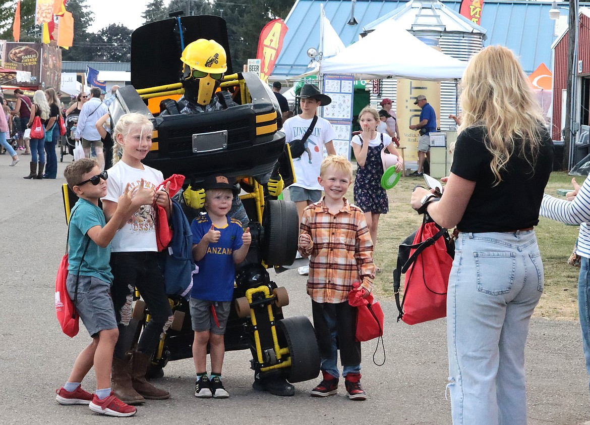 Kids pose with the Bumblebee character from the Transformers movie at the North Idaho State Fair on Wednesday. From left, Elias Anderson, Avery Tarbutton, Asa Tarbutton and Merrick Tarbutton.