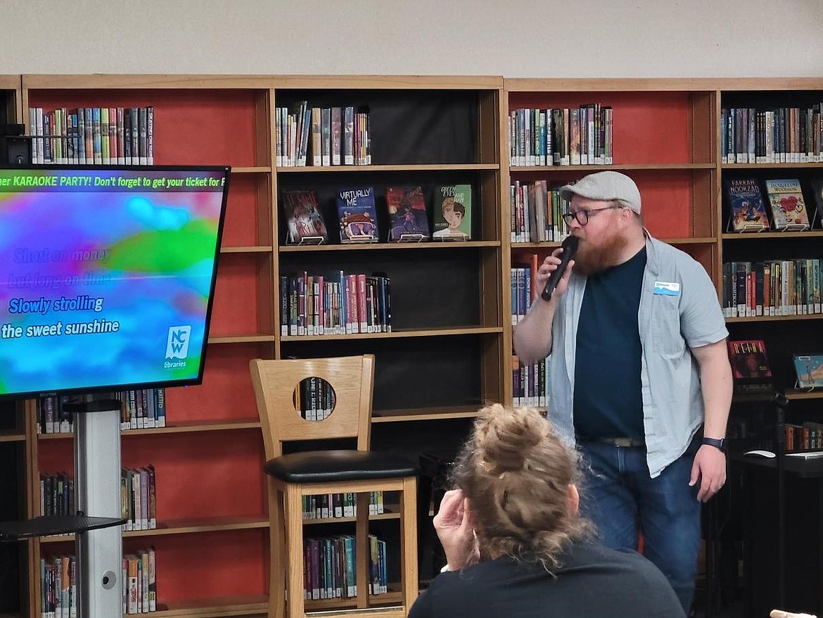 Ephrata Library Supervising Librarian Aaron Loeffelbein gets the fun started during a Tuesday evening karaoke party at the library. About 20 people attended the event, including children, parents and folks that just wanted to have fun singing.