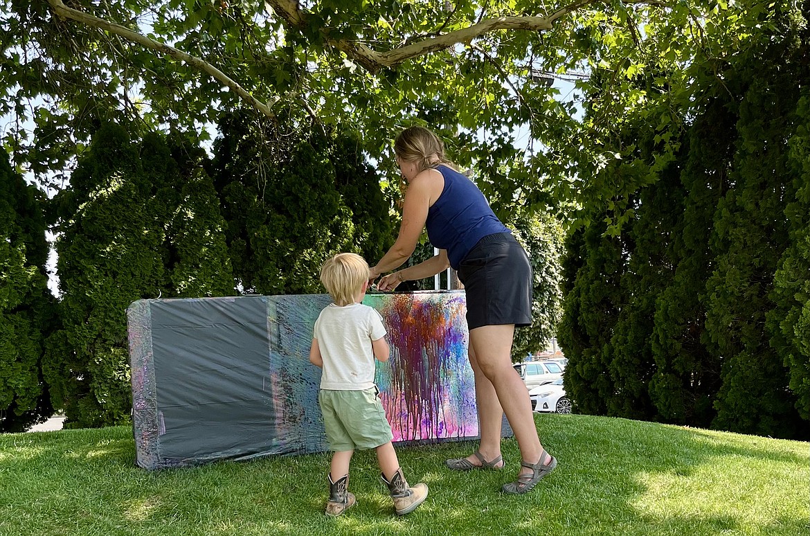 A mother and her child participate in an August 8 Splatter Paint session at the Ephrata Library.