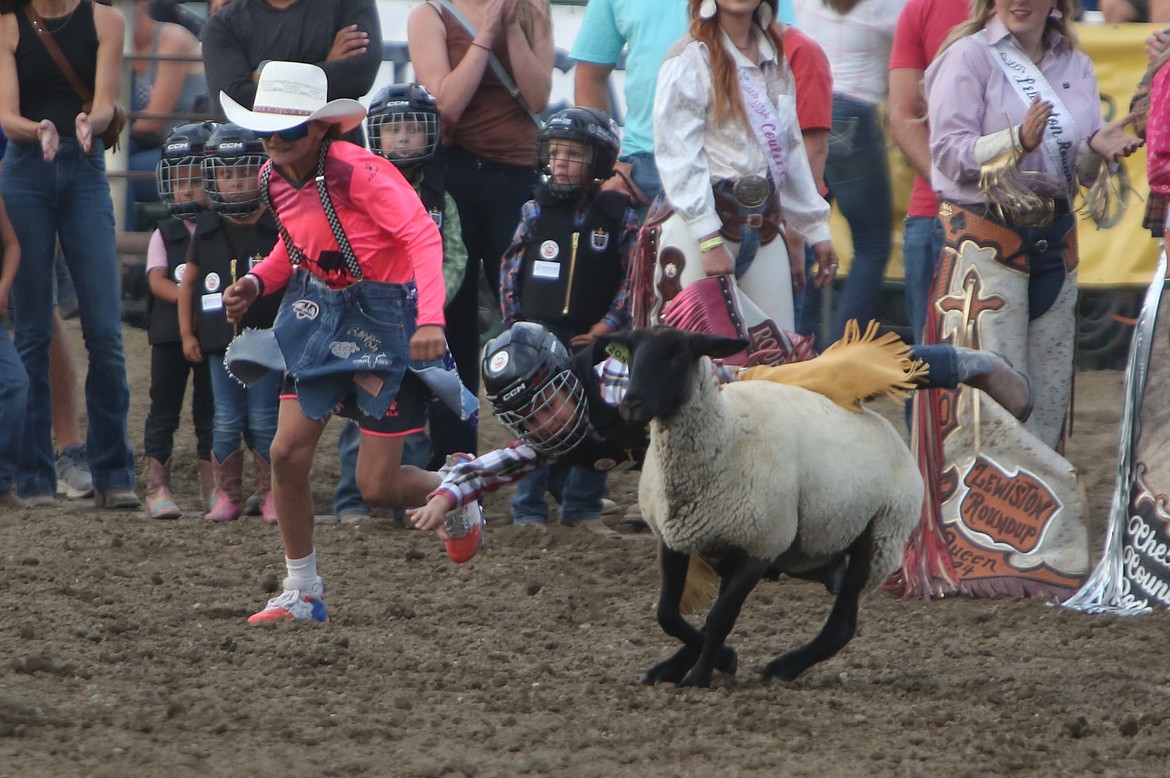 Pre-rodeo festivities included mutton bustin’, where children rode on top of sheep and received loud reactions from spectators in the crowd.