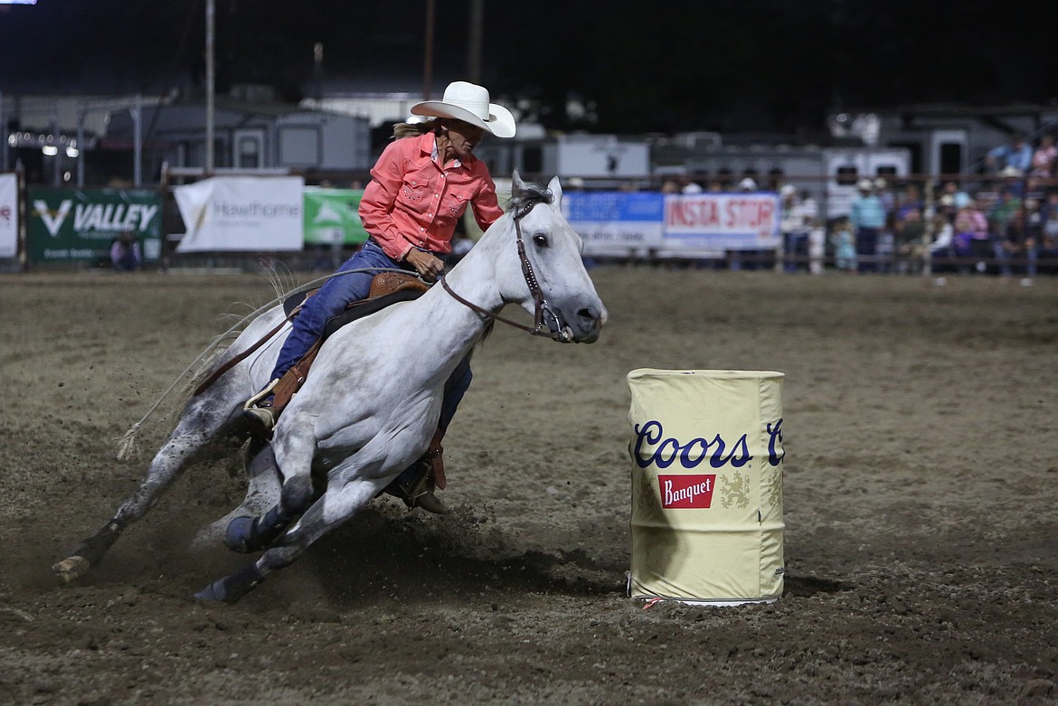 Cheney native Pamela Capper-Coker turns around a barrel during Saturday’s barrel racing competition at the Moses Lake Roundup.