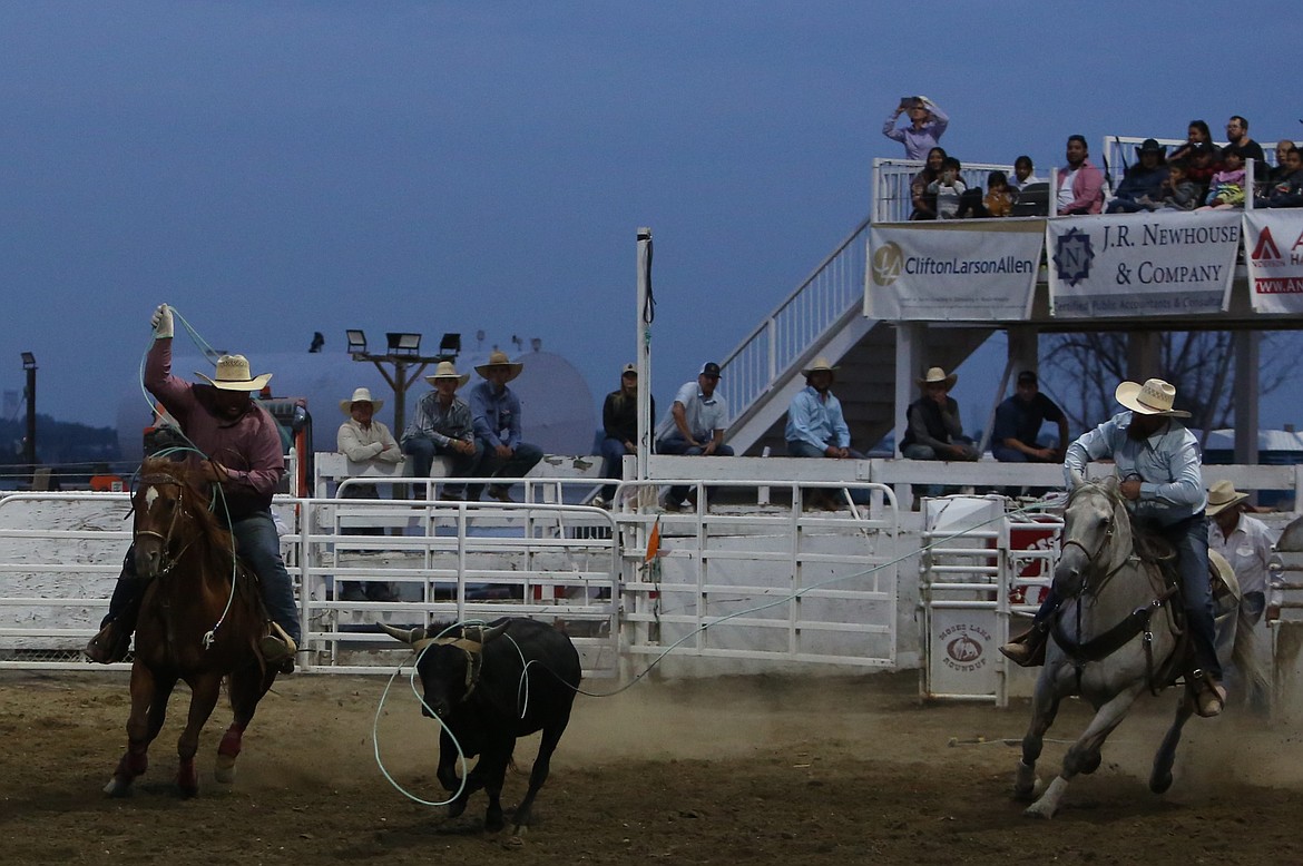 The team roping tandem of Matt Meyer, from Toppenish, and Brent Baggarley, from Yakima, enter the arena while attempting to rope at steer on Thursday.