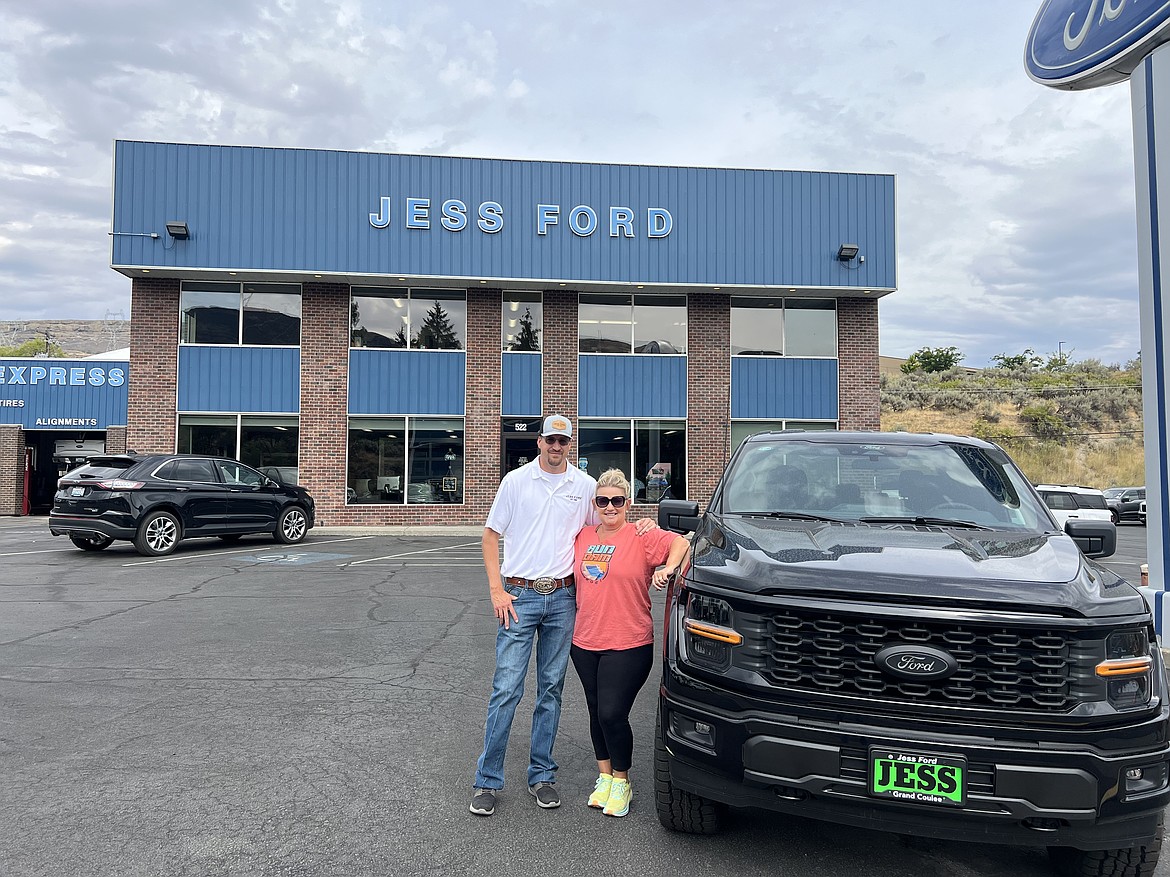 Garrett Jess, left, and Kelly Buche, right, pose for a photo outside the Jess Ford dealership in Grand Coulee. Jess Ford is hosting the Swing for the Good charity golf scramble early next month, benefiting Run for the Dam, which is run by Buche.