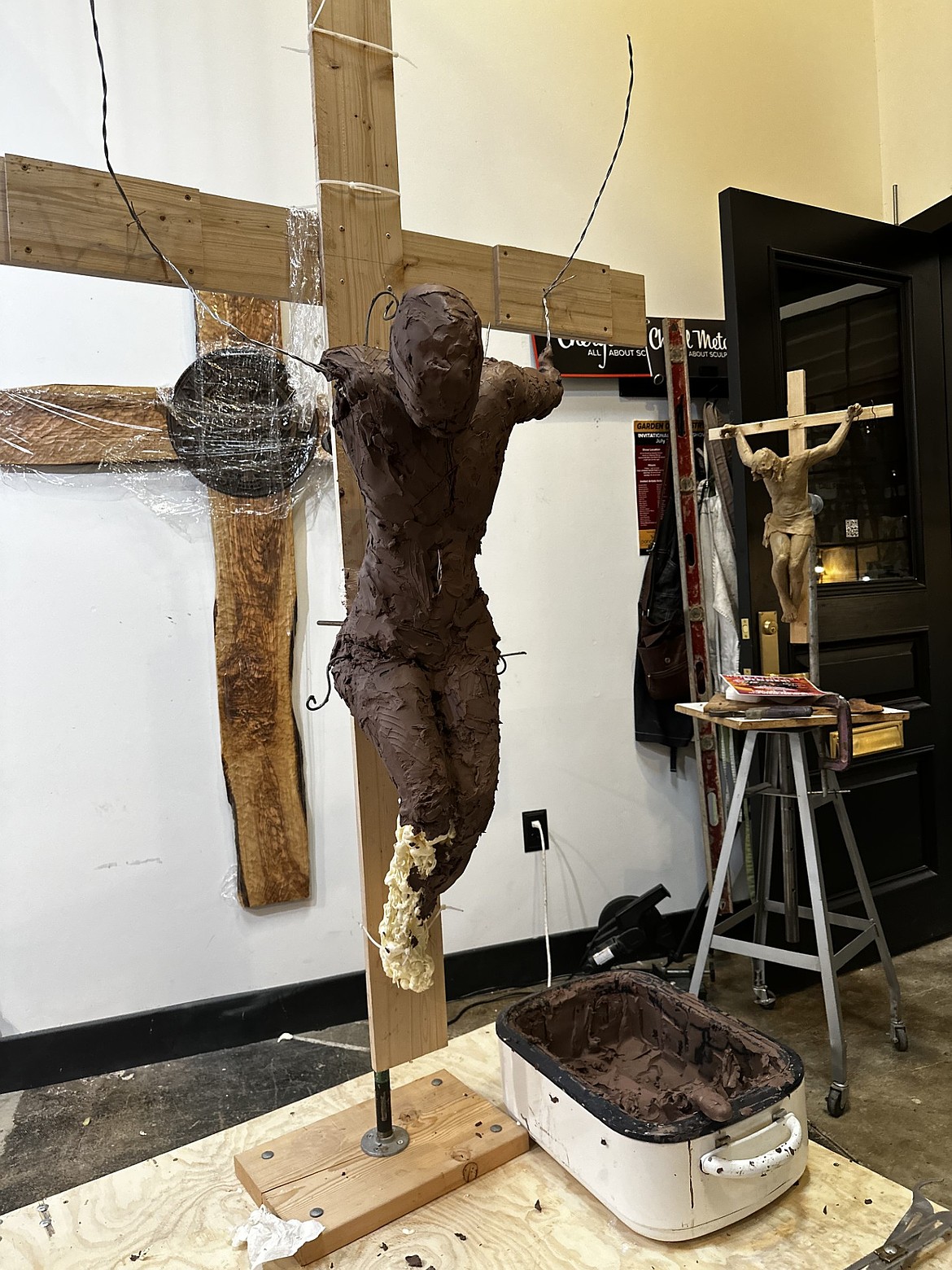 An early phase of the clay Cheryl Metcalf is sculpting into Jesus Christ on the cross is seen in her studio earlier this year.