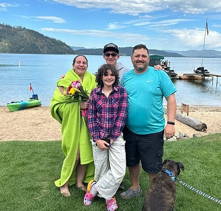 Kim Bowler is joined by her family after completing her swim across Priest Lake on Tuesday.