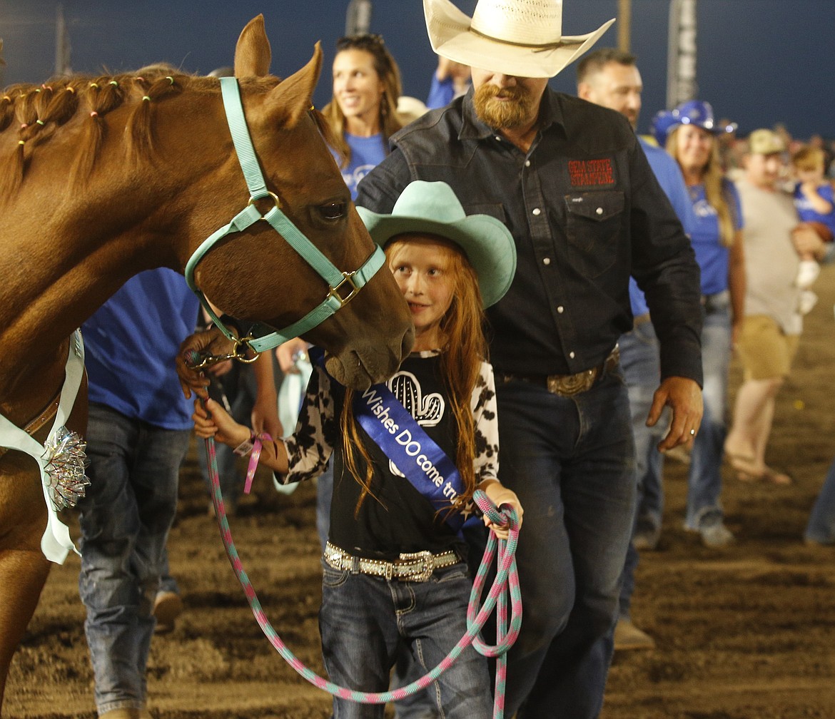 The crowd cheered when Kinsley, 8, received a horse named Tucker.