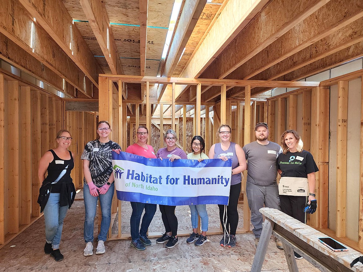 Members of the Precision Tax team proudly show off their work done with Habitat for Humanity of North Idaho.