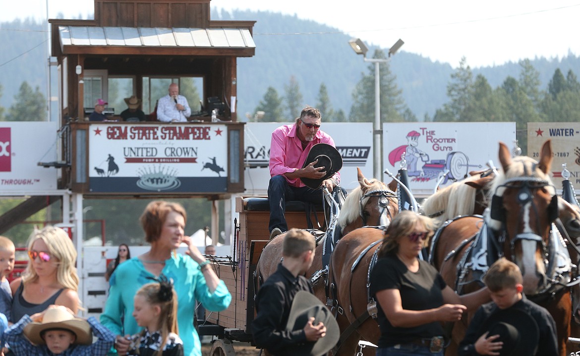 Darin Nagle, a great-nephew of Don Nagle, holds his cowboy hat in his hands as Don is remembered during a moment of silence Friday morning. Don, who was instrumental in regional draft horse programs and events, died Thursday. Four of his Nagel Belgian hitches participated in the performance class.