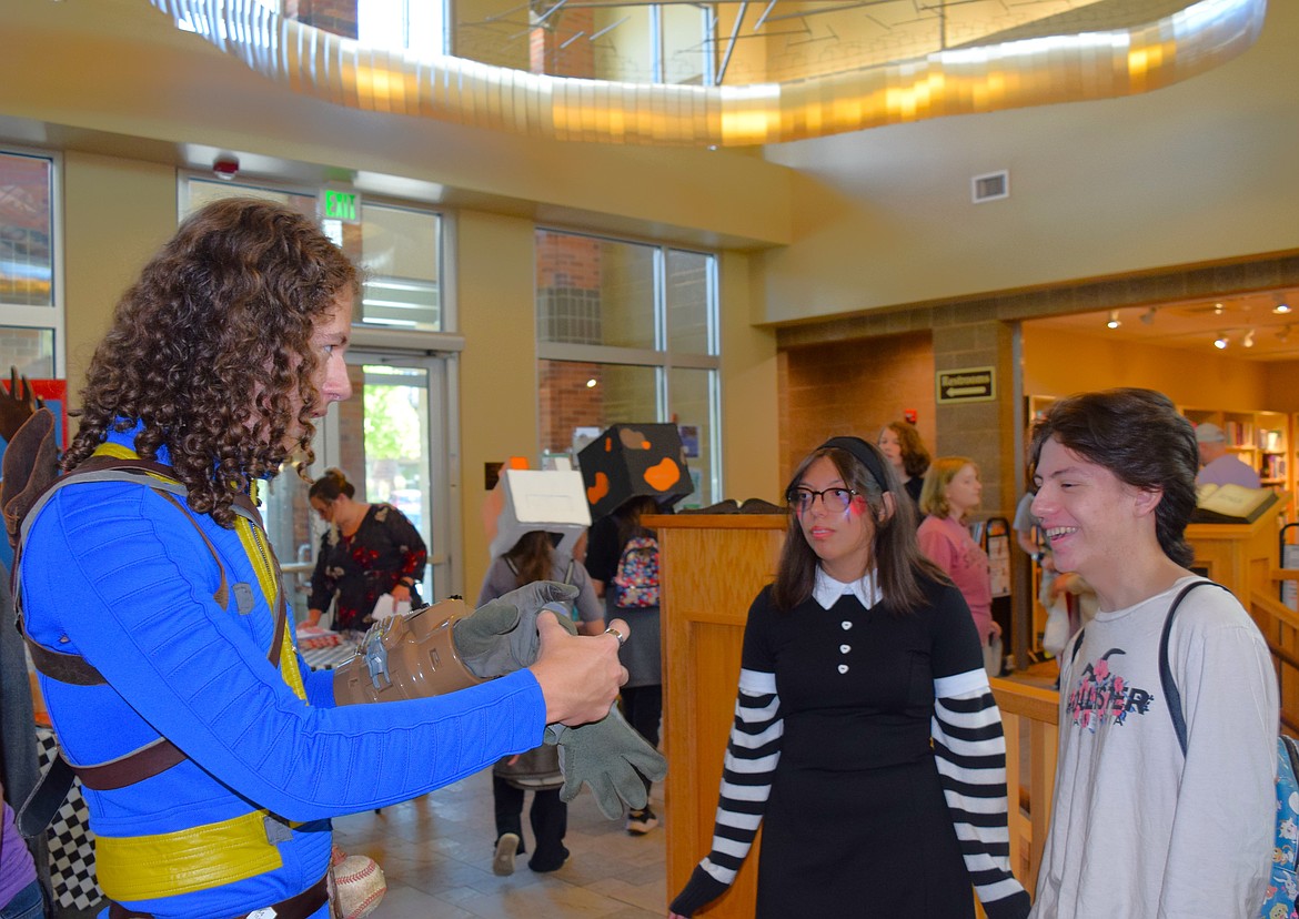 Aidan Vincent shows off his "Fallout Guy" cosplay to Christian and Alaina Cole at Saturday's Couer d'Con.