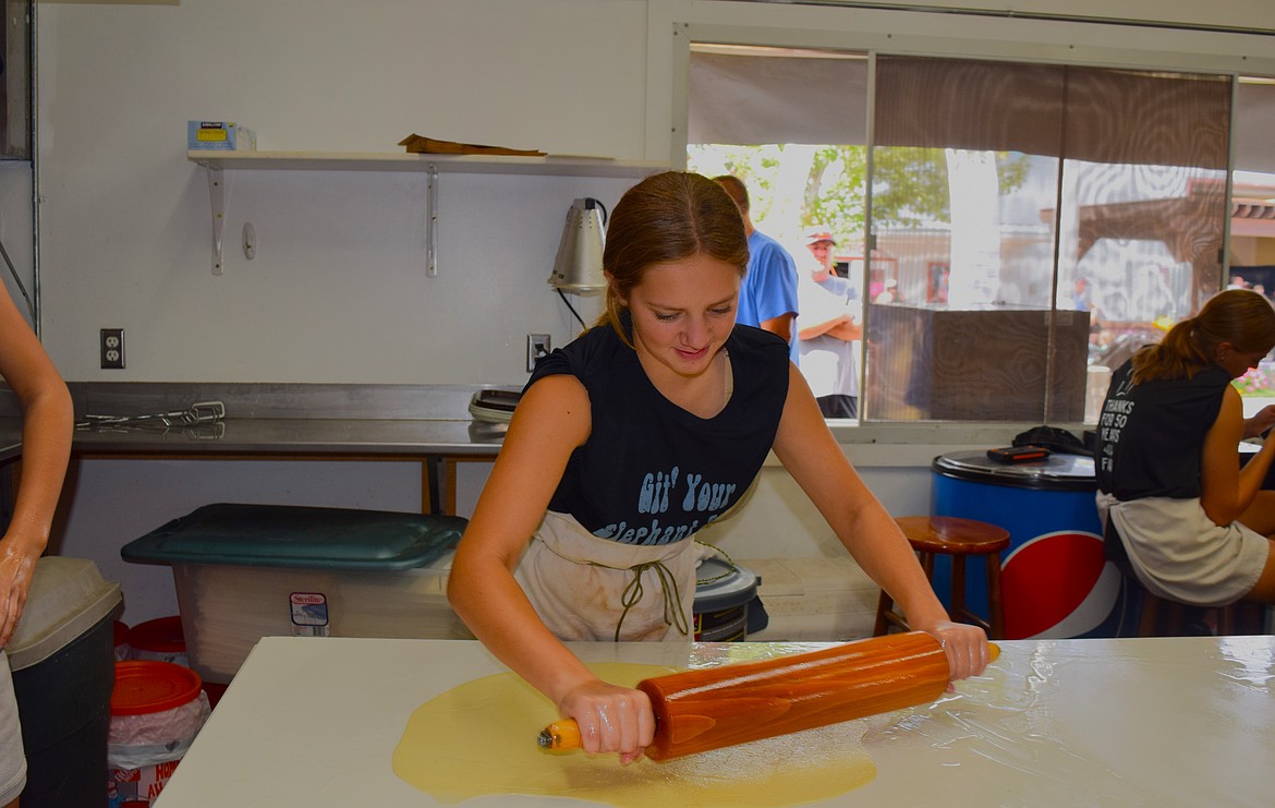 LouCylle Davis rolls out the elephant ear dough, made with the same family recipe since 1974.