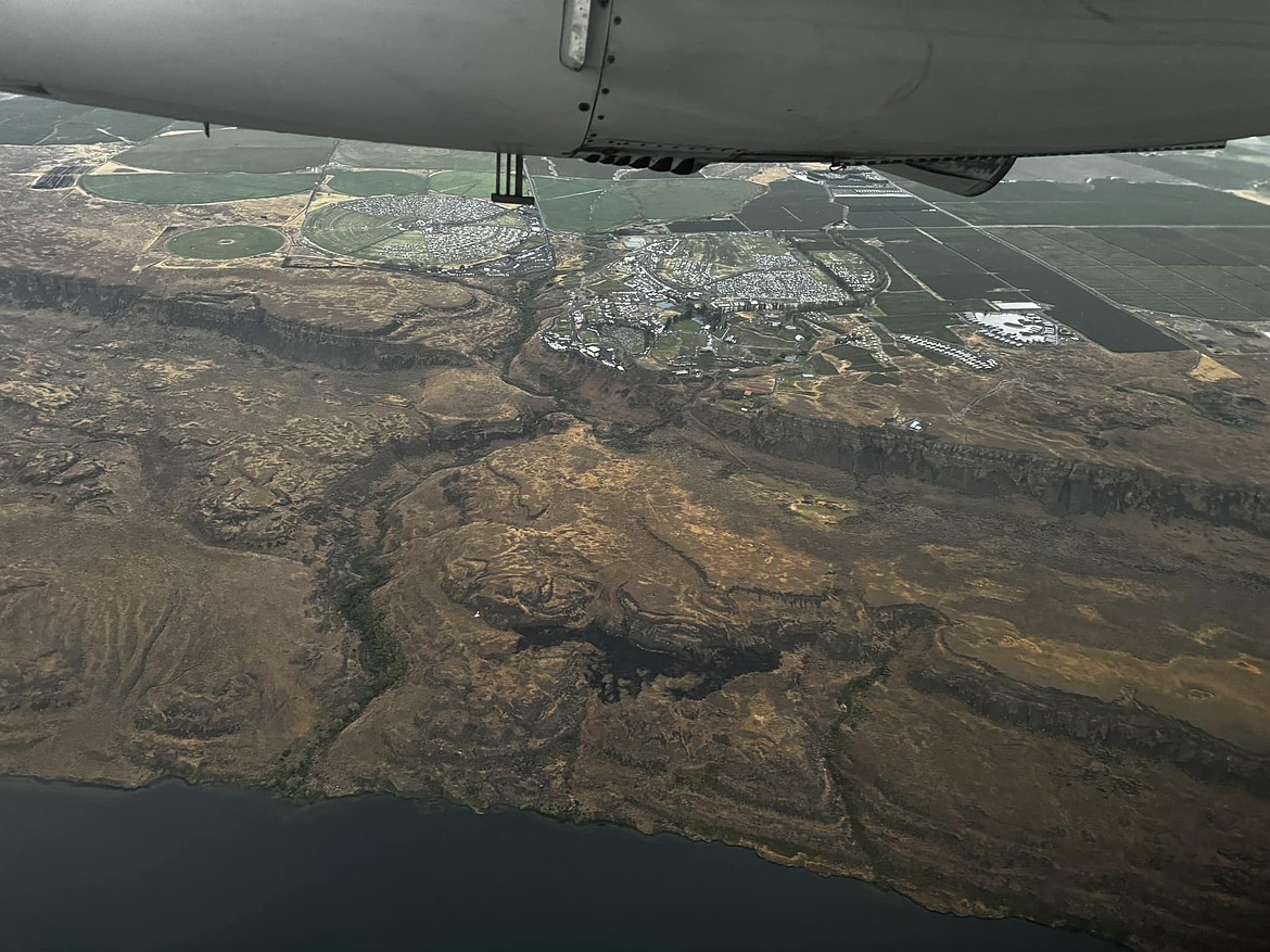 A small wildfire and inclement weather shut down The Gorge Amphitheater venue Friday during a concert. The fire burned about five acres and the remnants can be seen as a black splotch in this photo.