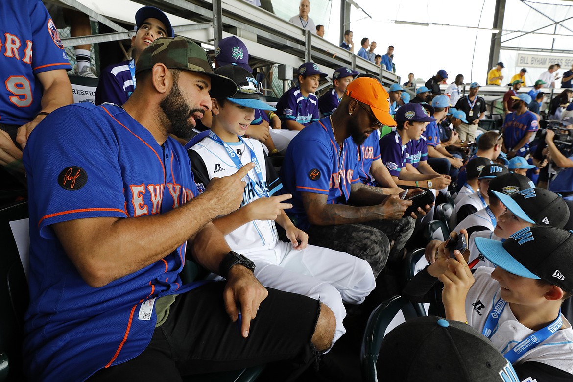 GENE J. PUSKAR/Associated Press
Jose Bautista of the New York Mets has a picture taken with AJ Currie of Coeur d’Alene Little League while taking in an International pool play game at the Little League World Series in South Williamsport, Pa., on Sunday, Aug. 19, 2018. The Mets played the Philadelphia Phillies in the Little League Classic in Bowman Stadium in Williamsport, Pa., that night.