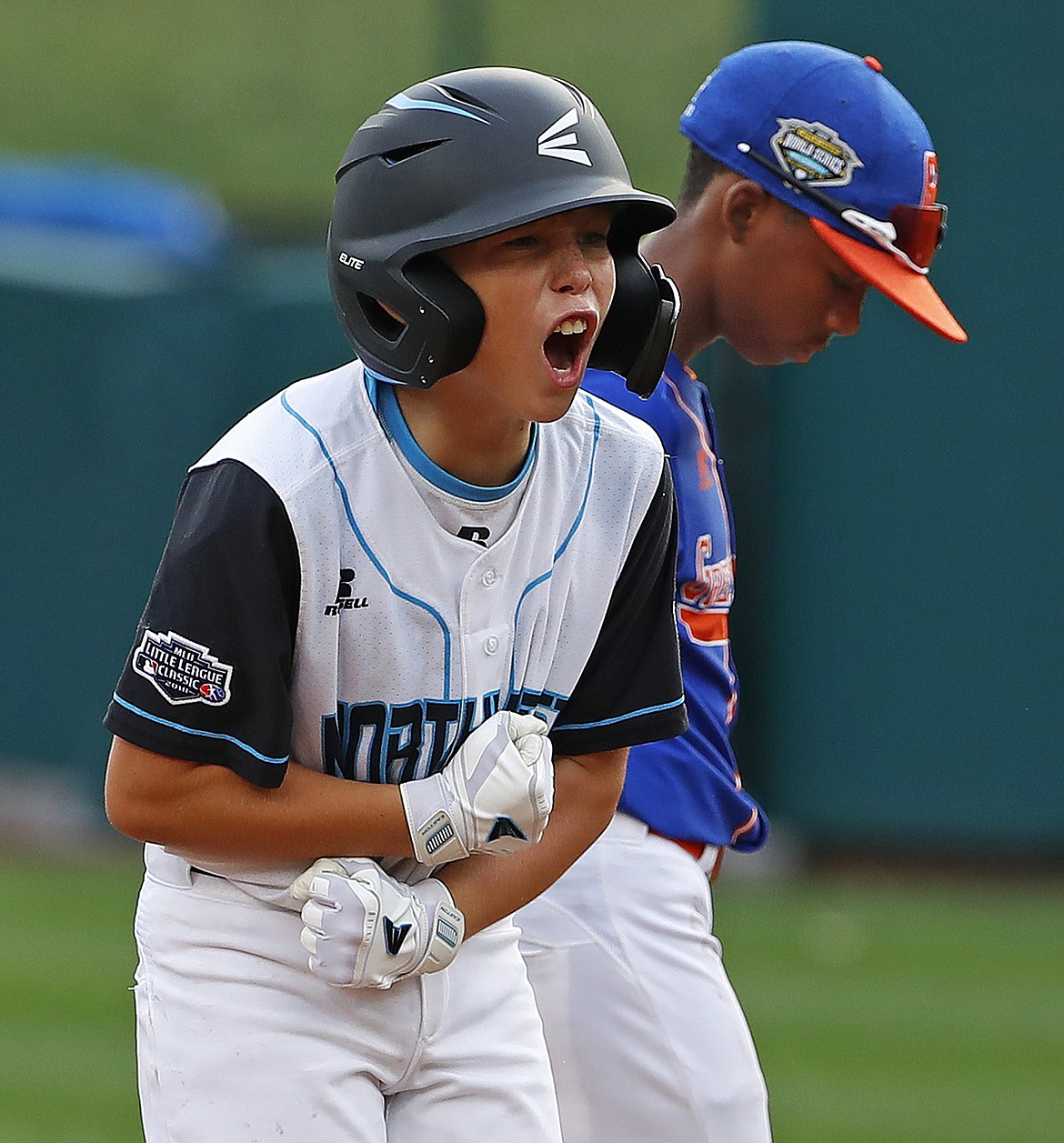 GENE J. PUSKAR/Associated Press
Coeur d’Alene’s Caden Symons celebrates in front of Reggie Sharpe of Grosse Pointe Woods, Mich., as he stands on second after driving in two runs with a double in the second inning in United States pool play at the Little League World Series in South Williamsport, Pa., on Friday, Aug. 17, 2018.